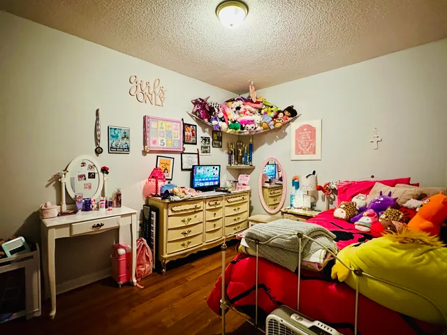 a bedroom with a bed and a desk