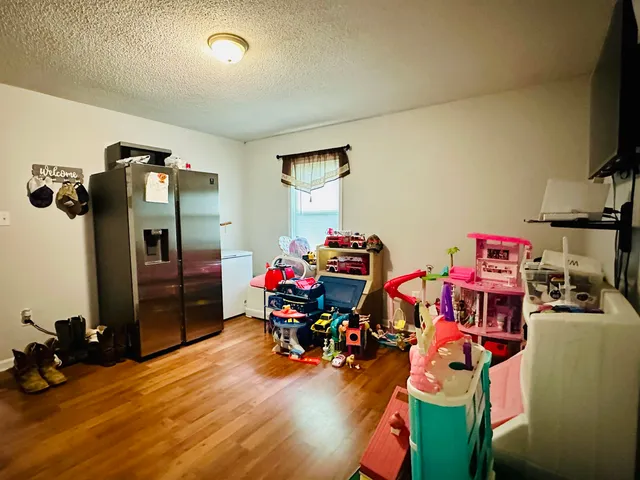 a bedroom with furniture and a flat screen tv