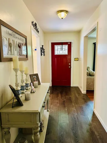 a view of a livingroom with furniture wooden floor and windows