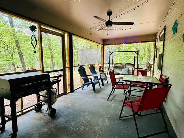 a living room with furniture a table and a large window
