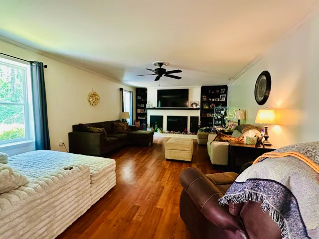 a living room with furniture fireplace and window