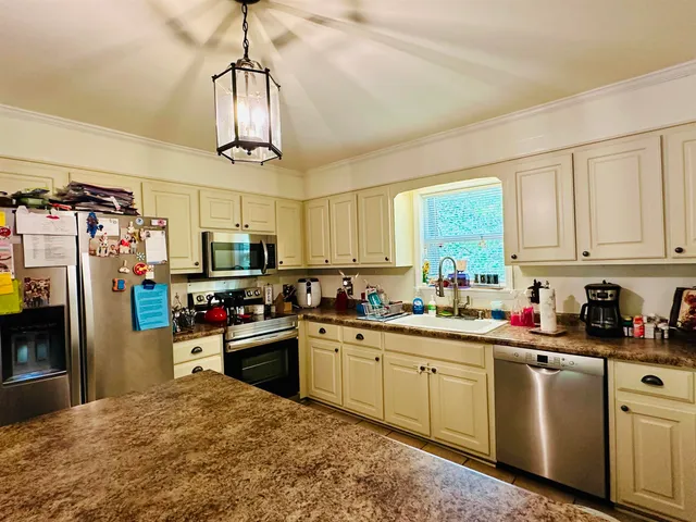 a kitchen with refrigerator a sink and cabinets