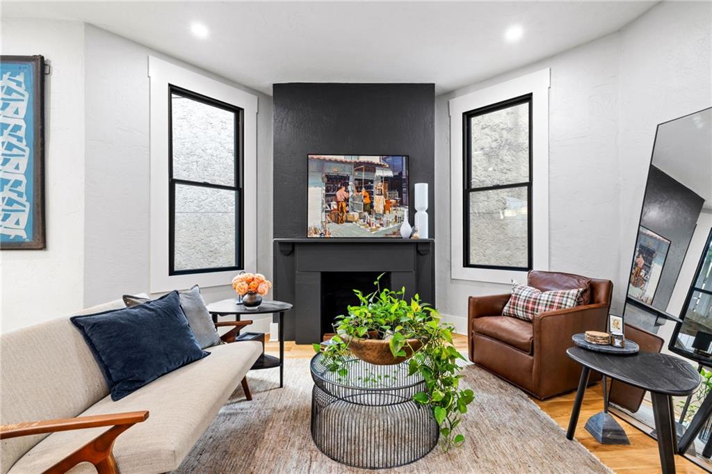 720 Ivy Street Pittsburgh, PA 15232 - Photo 22 of 50 a living room with furniture and a fireplace
