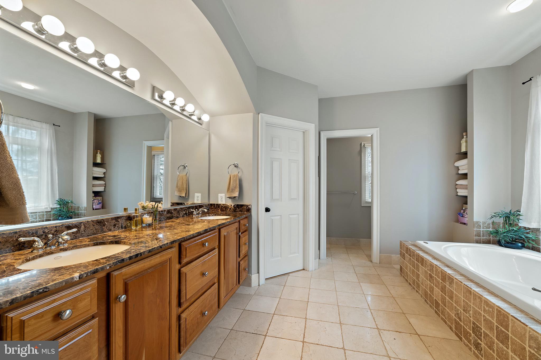 5462 Free State Road Marshall, VA 20115 - Photo 17 of 58 a spacious bathroom with a granite countertop double vanity sink a mirror and a bathtub