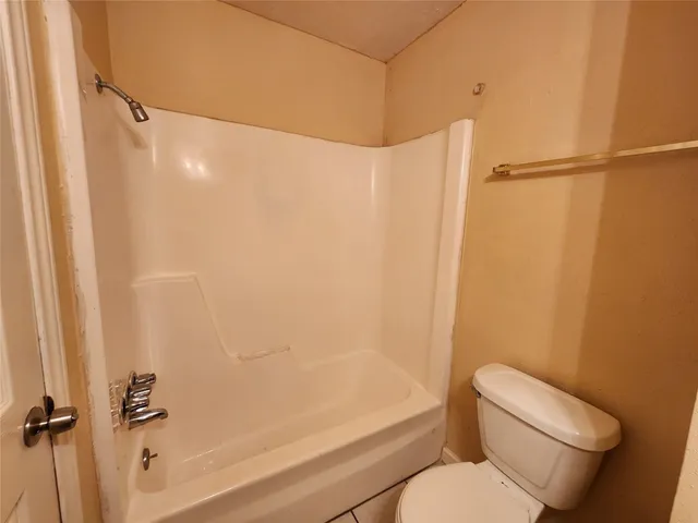 a bathroom with a toilet and a bathtub