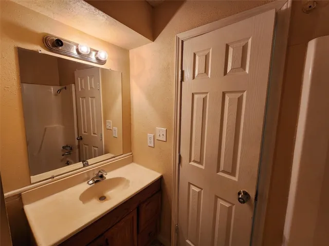a bathroom with a sink and mirror