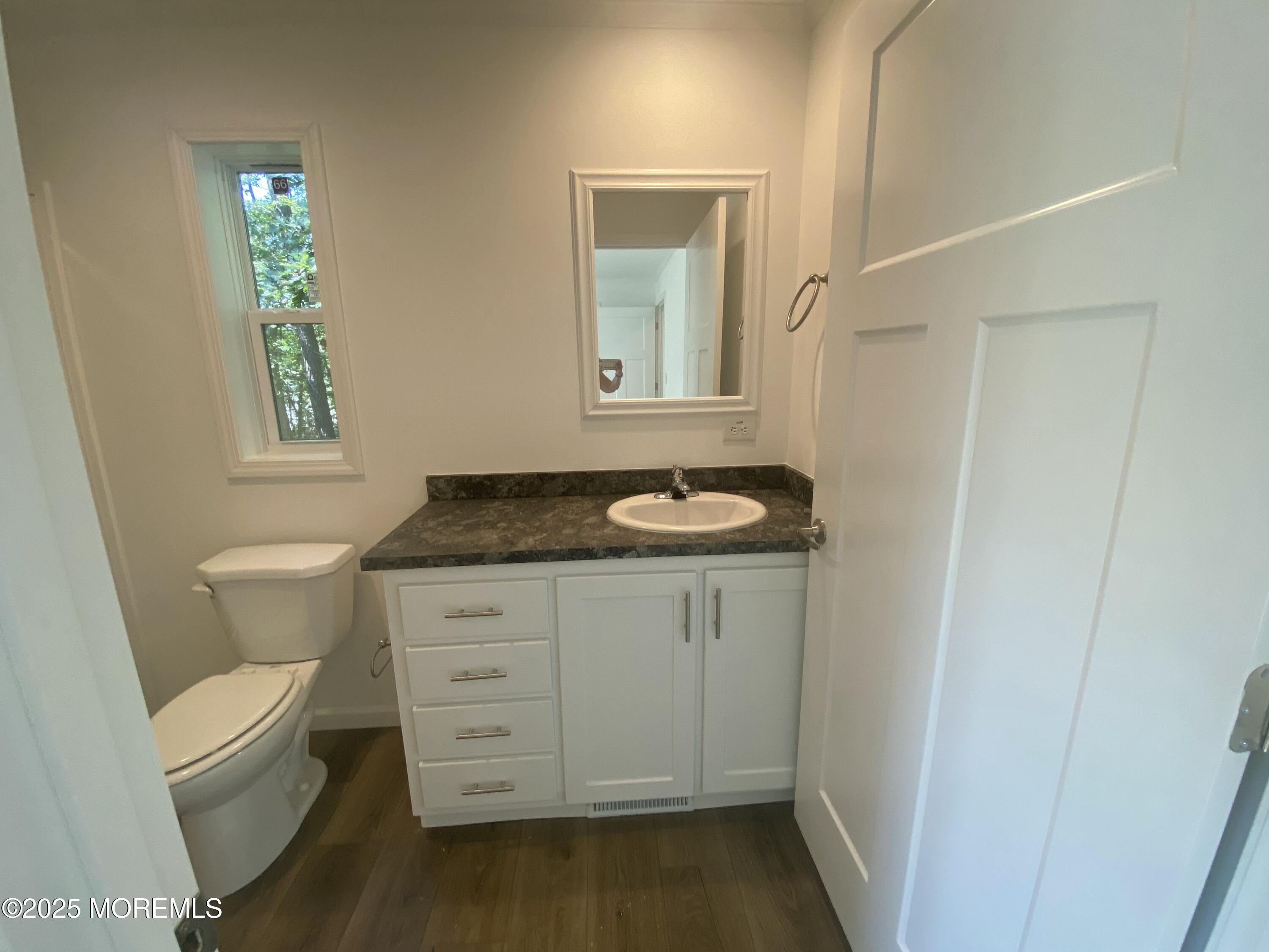 18 Maple Tree Court Manahawkin, NJ 08050 - Photo 15 of 21 a bathroom with a granite countertop sink toilet and mirror