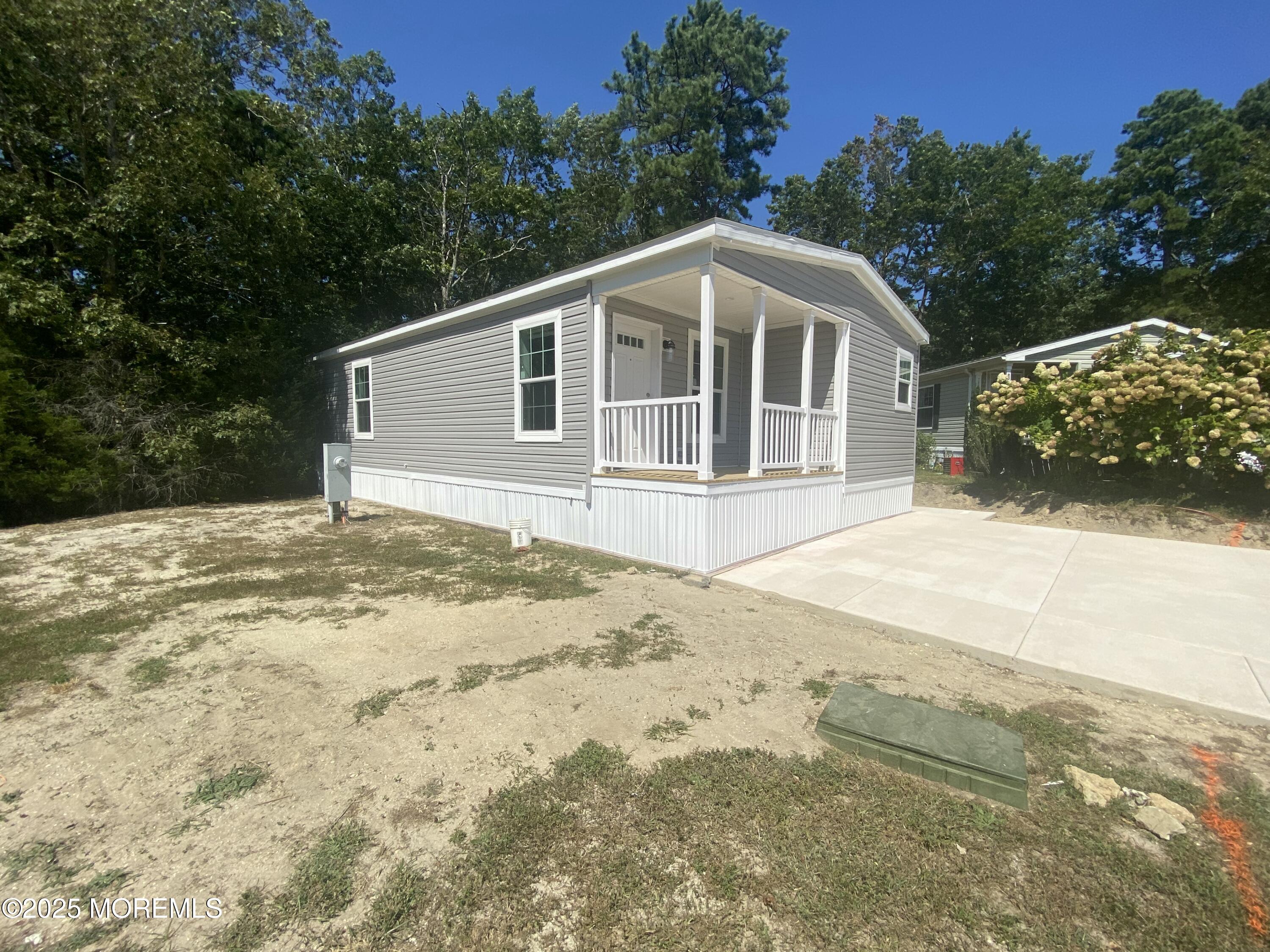 18 Maple Tree Court Manahawkin, NJ 08050 - Photo 21 of 21 a front view of a house with a yard