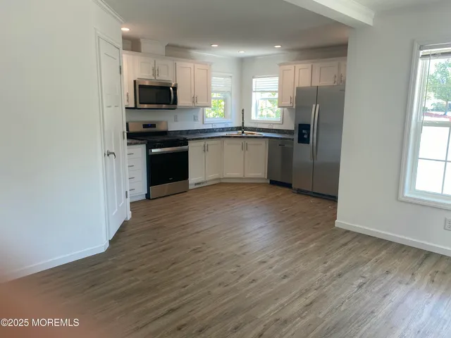 a kitchen with stainless steel appliances a refrigerator sink and microwave