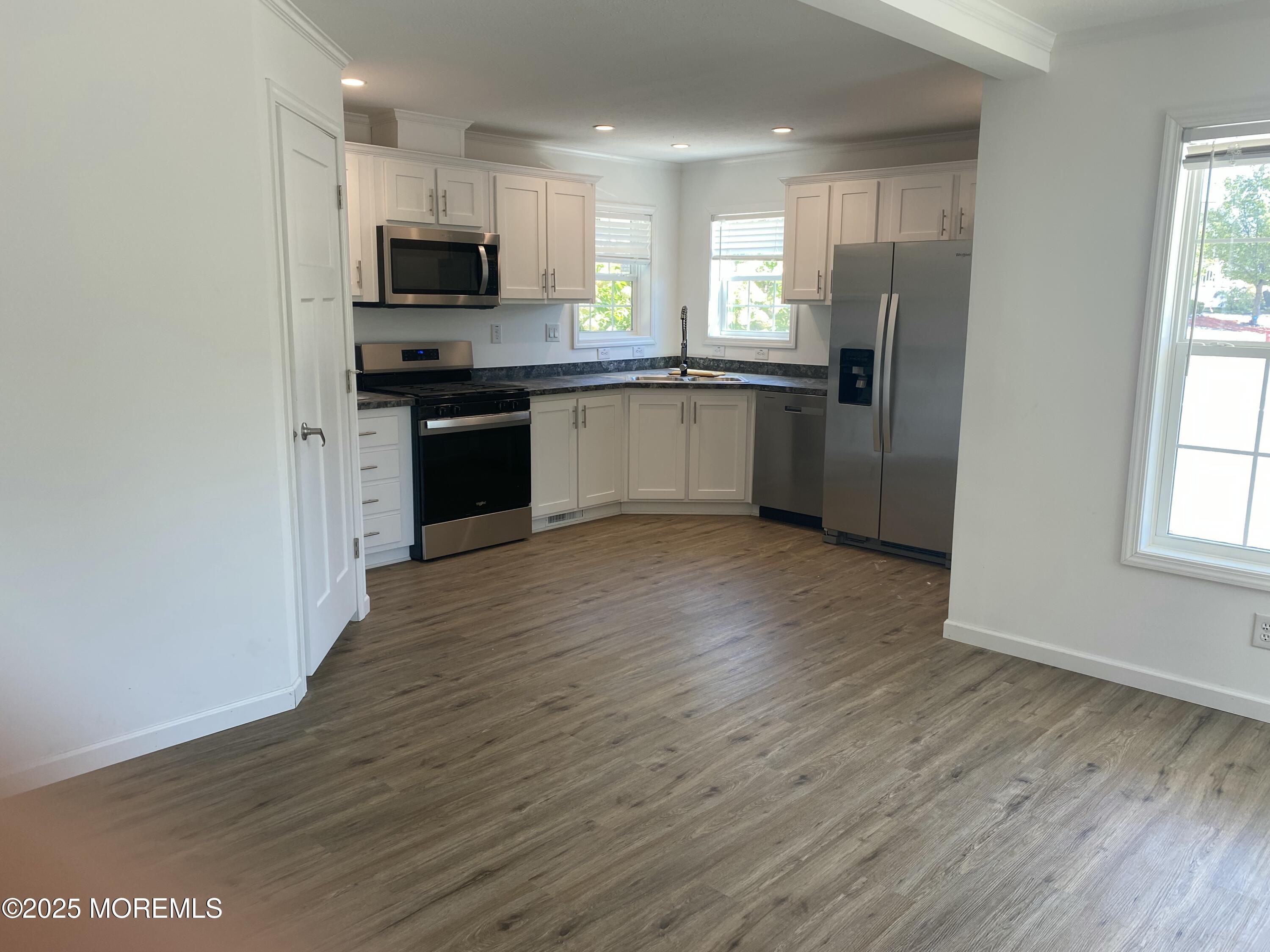 18 Maple Tree Court Manahawkin, NJ 08050 - Photo 3 of 21 a kitchen with stainless steel appliances a refrigerator sink and microwave