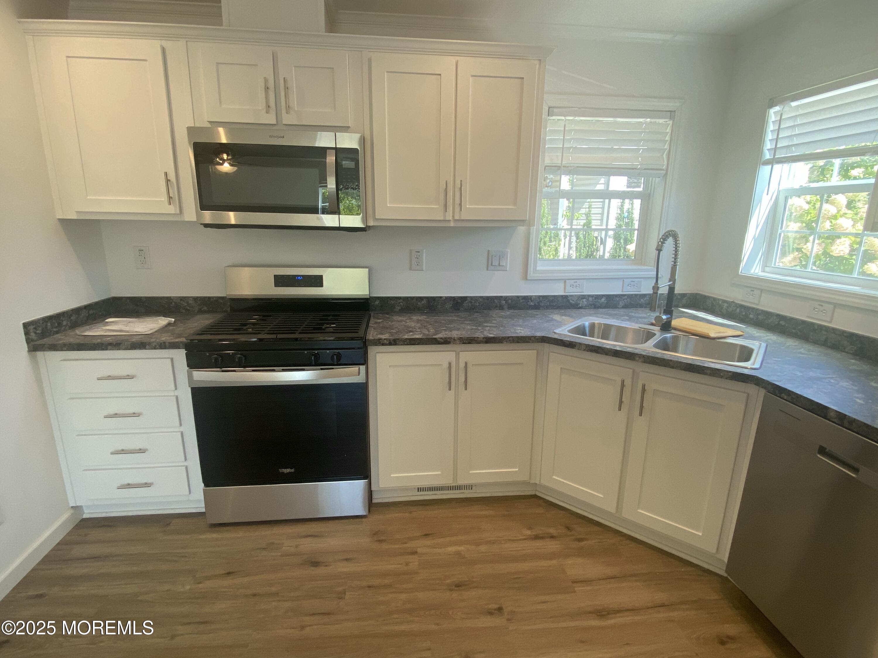18 Maple Tree Court Manahawkin, NJ 08050 - Photo 5 of 21 a kitchen with granite countertop a sink and a stove top oven