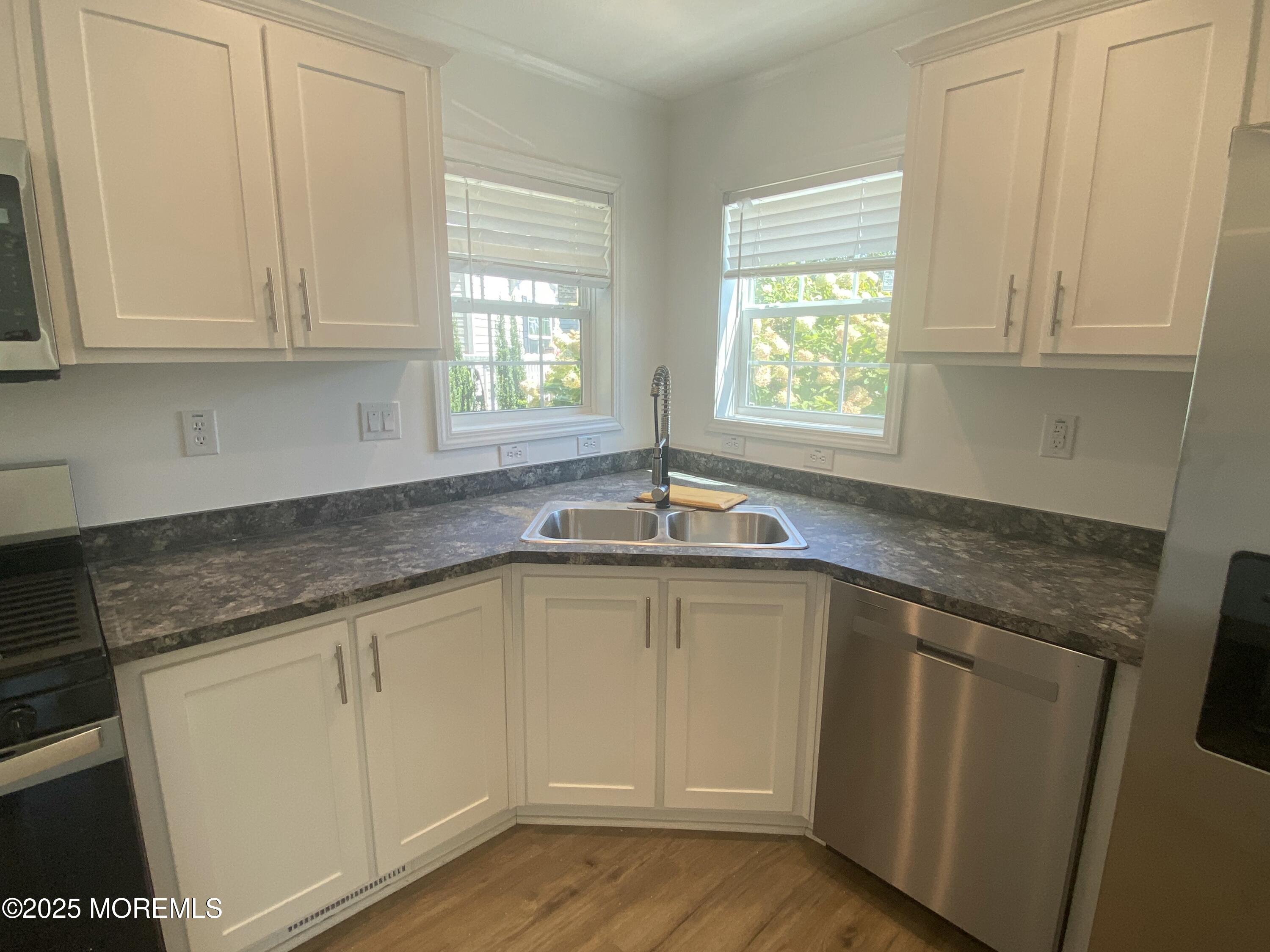 18 Maple Tree Court Manahawkin, NJ 08050 - Photo 6 of 21 a kitchen with granite countertop white cabinets and a sink