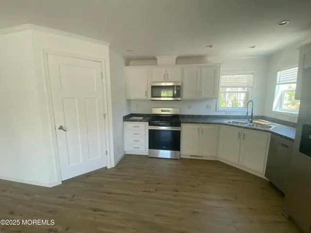 a kitchen with stainless steel appliances granite countertop a stove top oven a sink and dishwasher