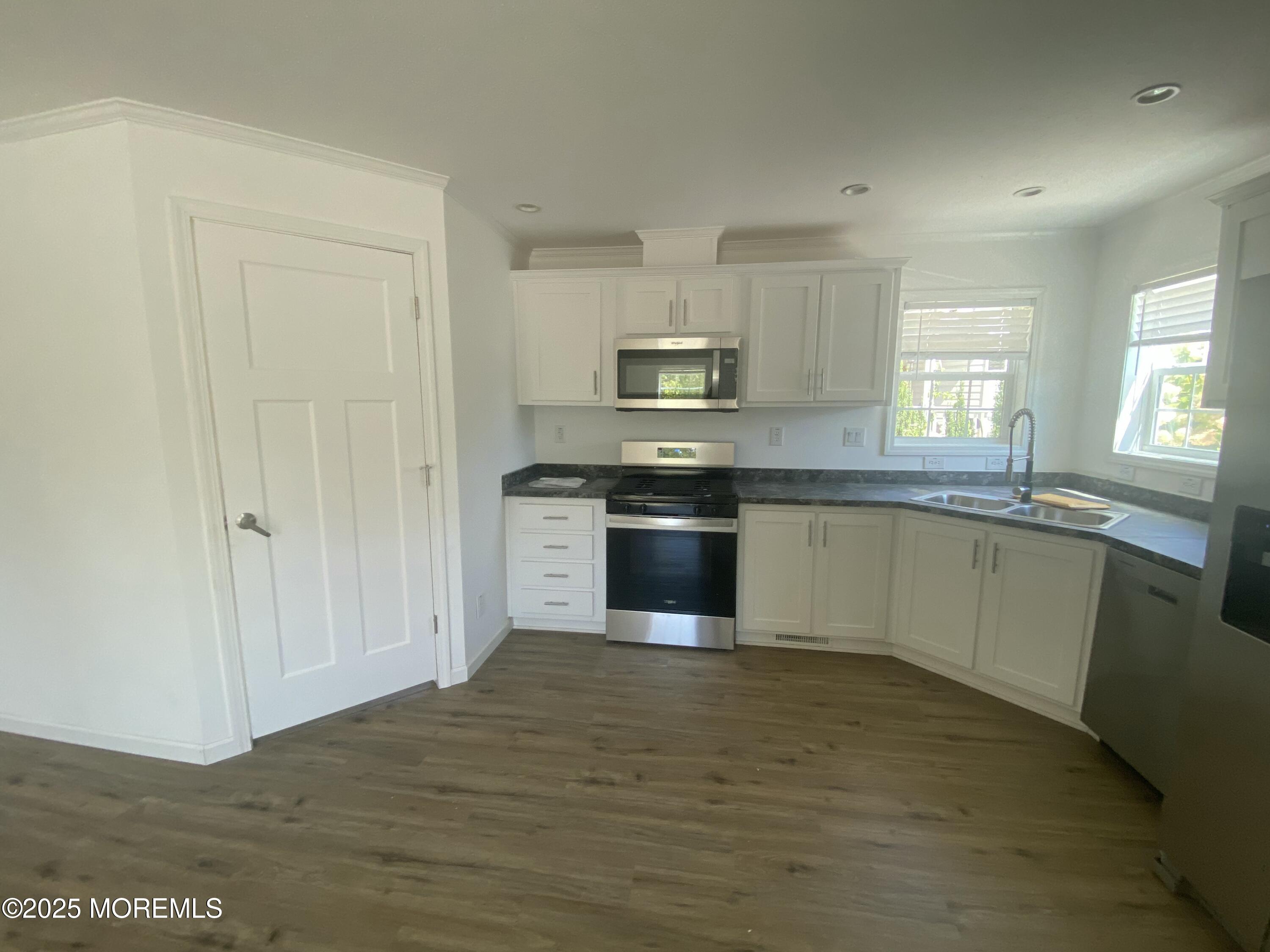 18 Maple Tree Court Manahawkin, NJ 08050 - Photo 7 of 21 a kitchen with stainless steel appliances granite countertop a stove top oven a sink and dishwasher