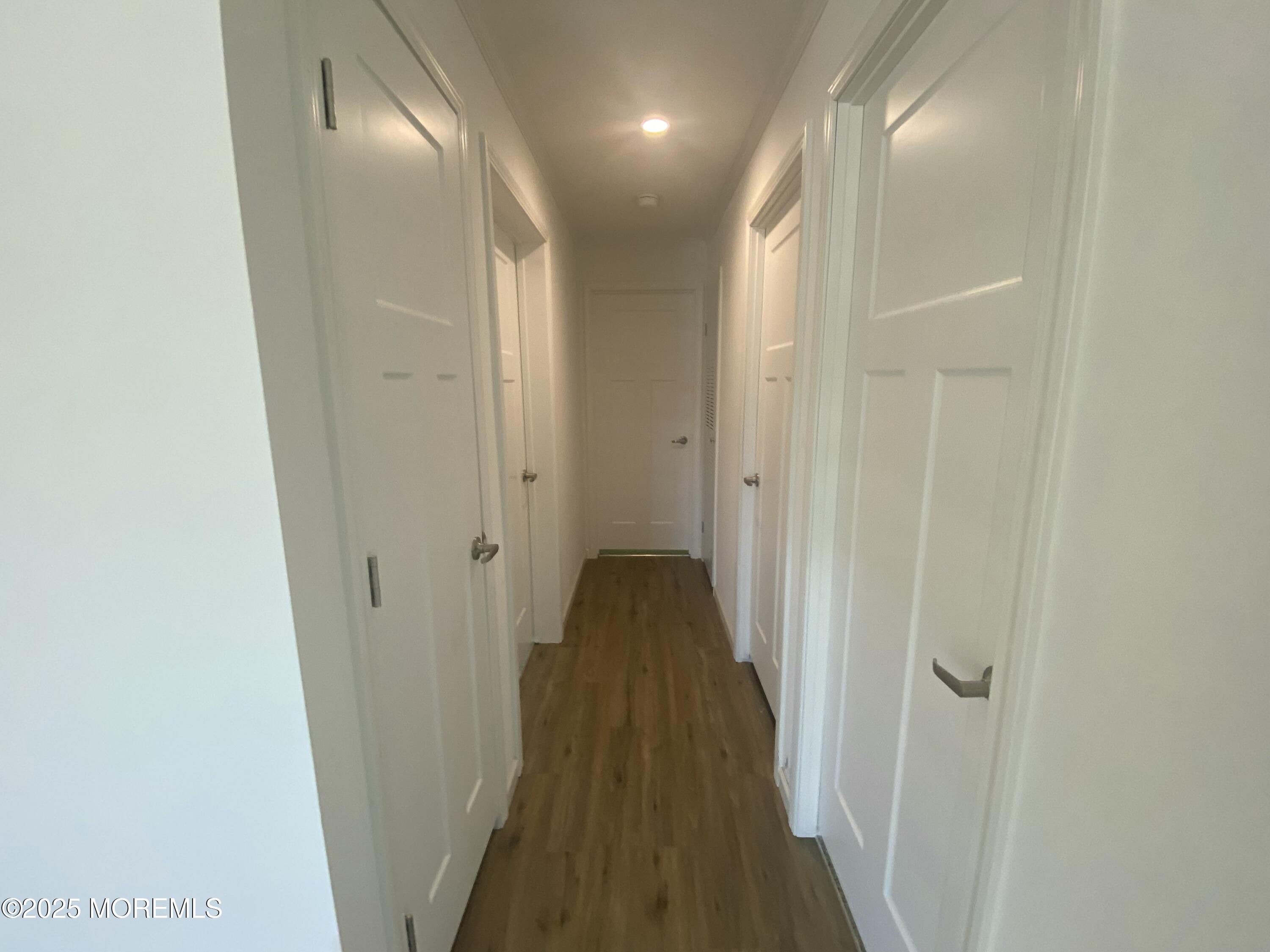 18 Maple Tree Court Manahawkin, NJ 08050 - Photo 10 of 21 a view of a hallway with wooden floor
