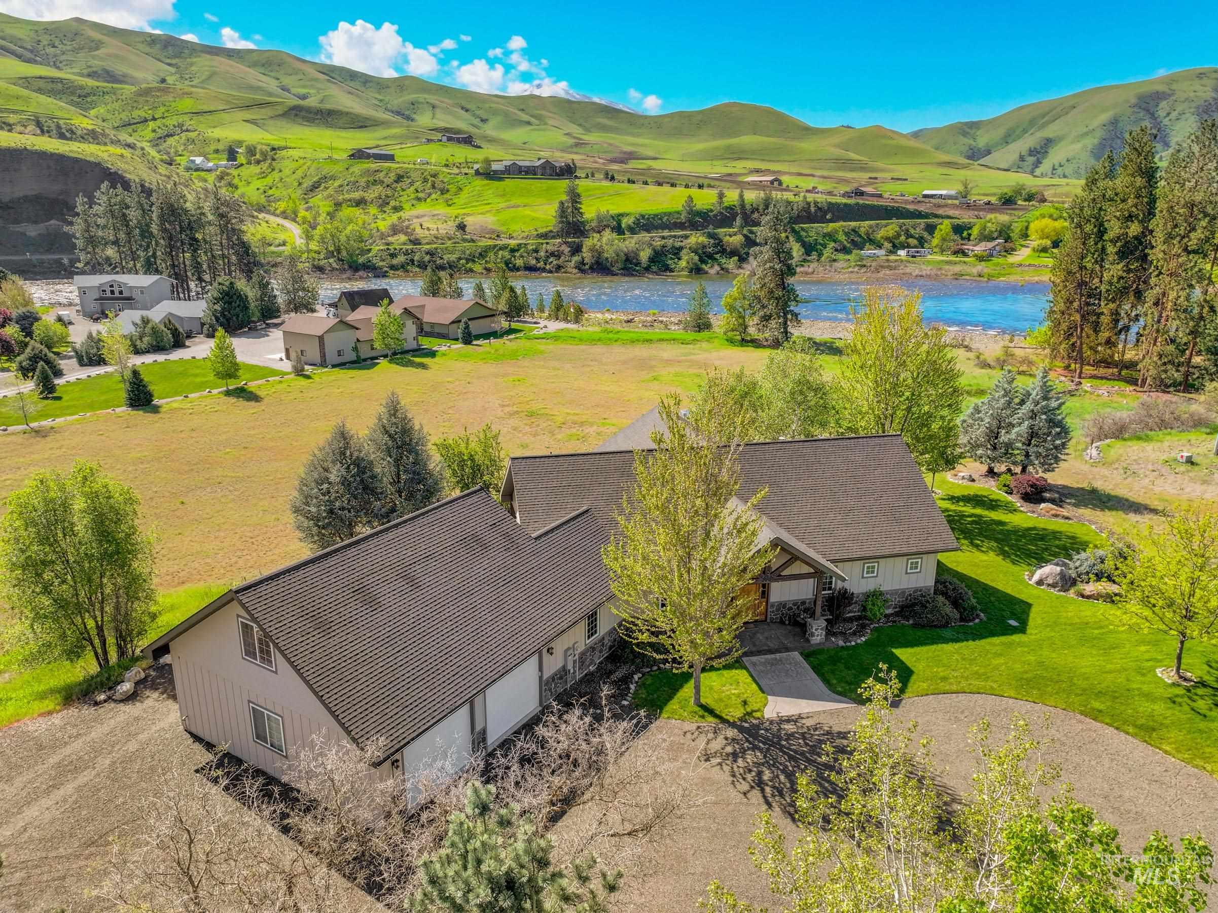 Spacious property featuring a large home with multiple gables and a dark shingle roof