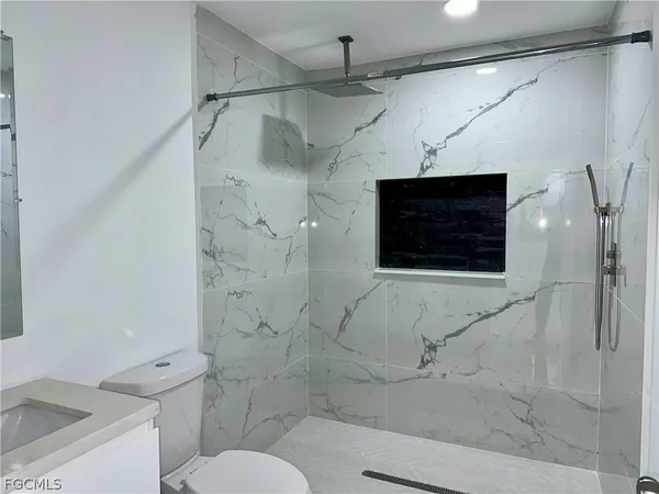 a bathroom with a shower and a toilet