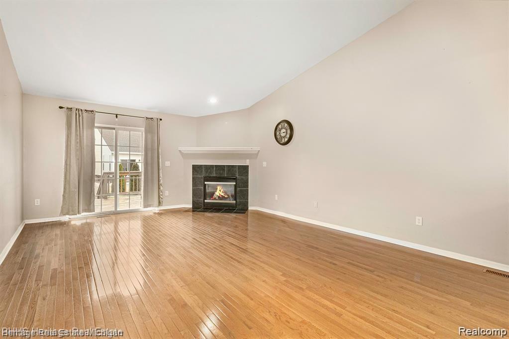 263 Wood Point, Unit 24 Howell, MI 48843 - Photo 4 of 15 Relax and enjoy the warmth of the corner fireplace!