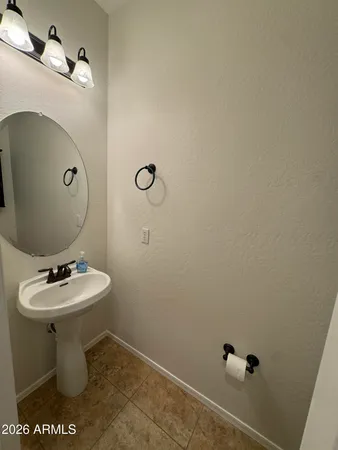 a white toilet sitting next to a bathroom sink