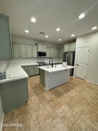 a large kitchen with kitchen island a sink window and stainless steel appliances