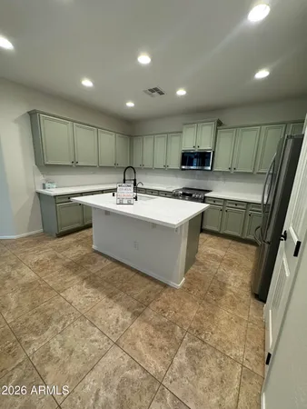 a kitchen with a sink a stove and cabinets