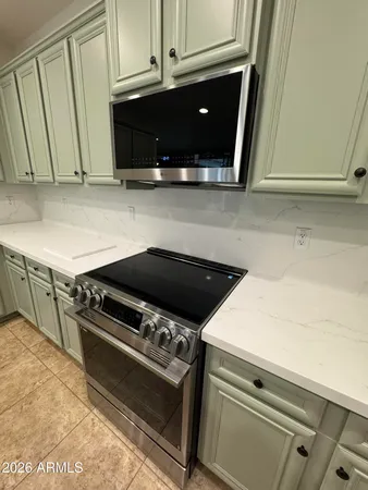a stove top oven sitting inside of a kitchen