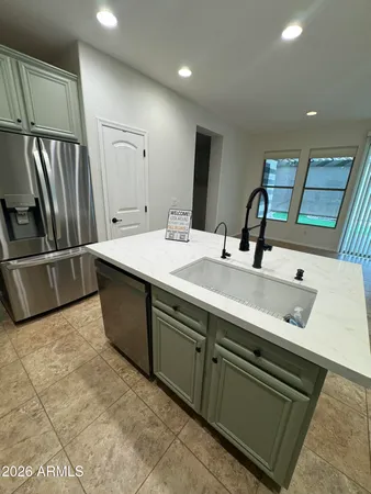 a kitchen with a sink stainless steel appliances and cabinets