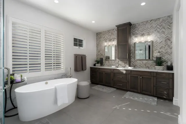a spacious bathroom with a double vanity sink large mirror and bathtub