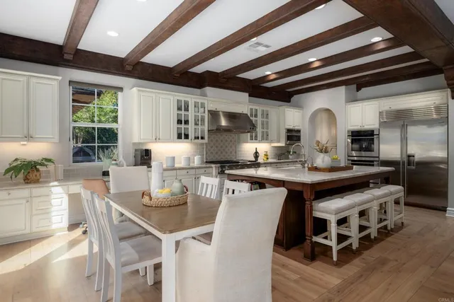 a kitchen with stainless steel appliances granite countertop a stove a sink dishwasher and a refrigerator