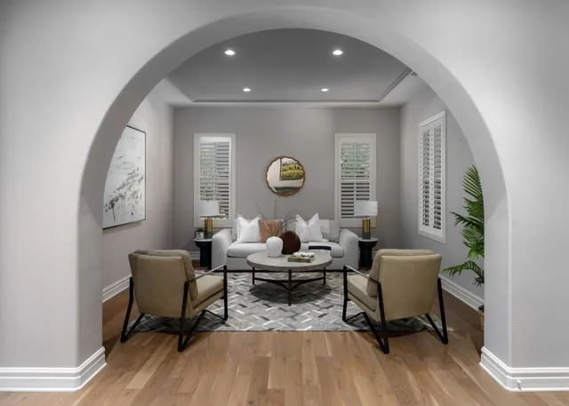 a living room with furniture and a potted plant