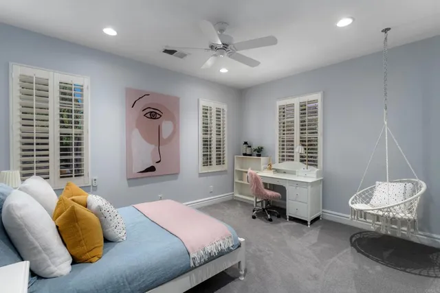a view of a patio with table and chairs under an umbrella with a small yard