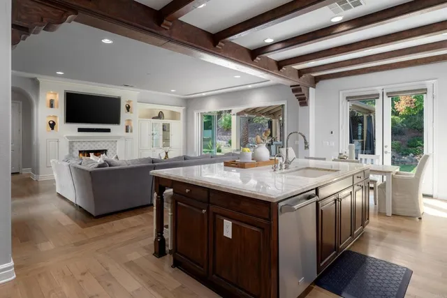 a kitchen with a stove and a flat screen tv