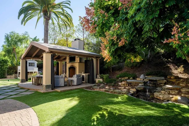 a view of a patio with table and chairs and potted plants