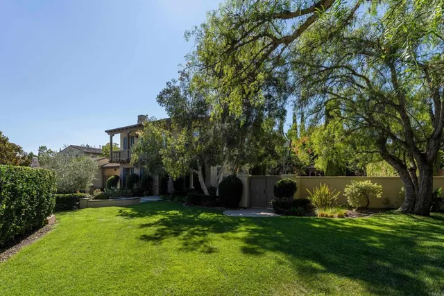 an aerial view of a house with a yard and garden
