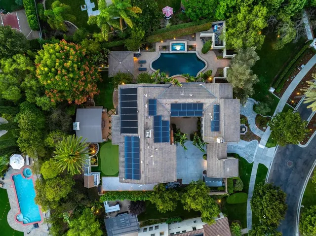 a swimming pool with outdoor seating and garden