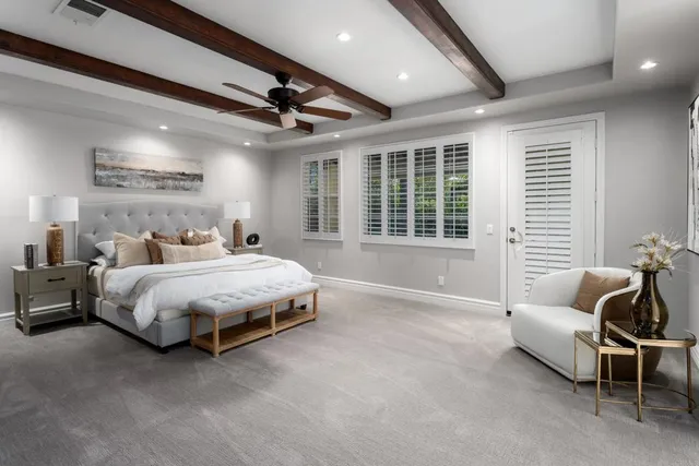 a spacious bedroom with a bed couch and a window