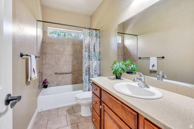 373 East Alexander Drive Elk Ridge, UT 84651 - Photo 16 of 69 Bathroom featuring a built-in tub with tile surround, a single vanity with an integrated sink and base cabinetry, and a full-width wall mirror