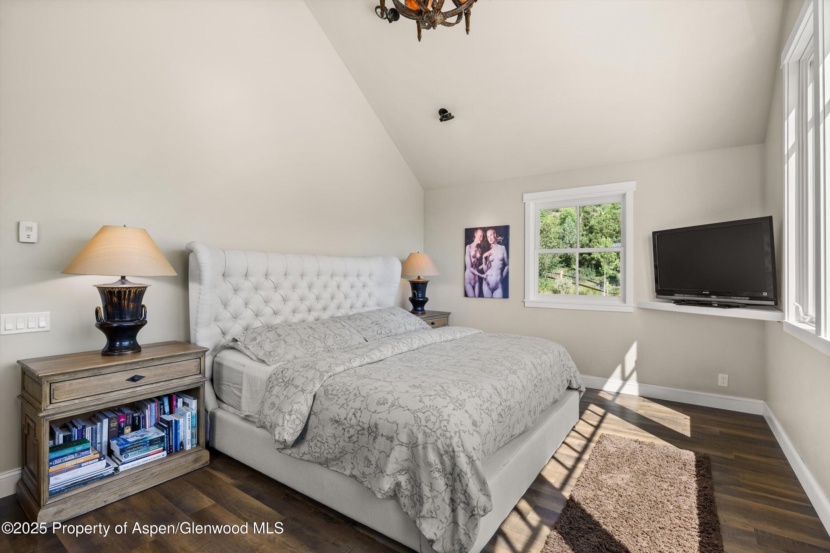 148 Gateway Road Snowmass, CO 81654 - Photo 13 of 32 a bedroom with a bed and a flat screen tv