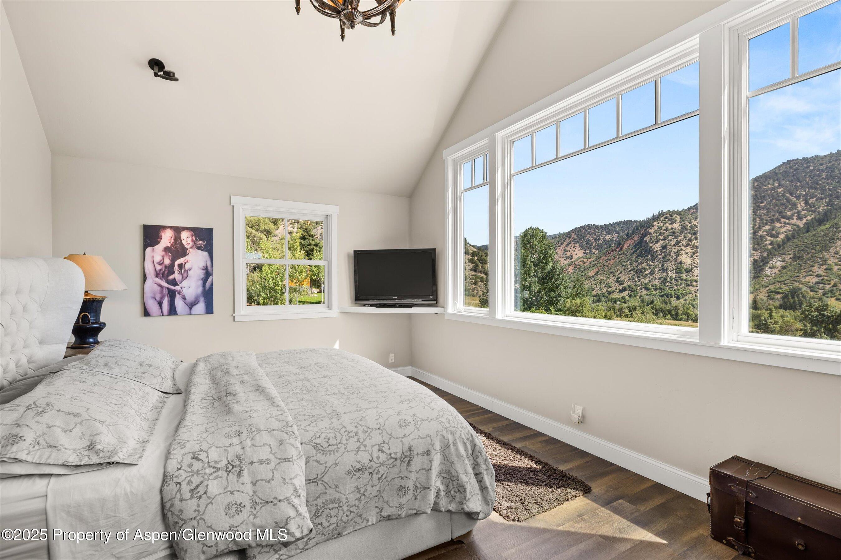 148 Gateway Road Snowmass, CO 81654 - Photo 14 of 32 a bedroom with a bed and a large window