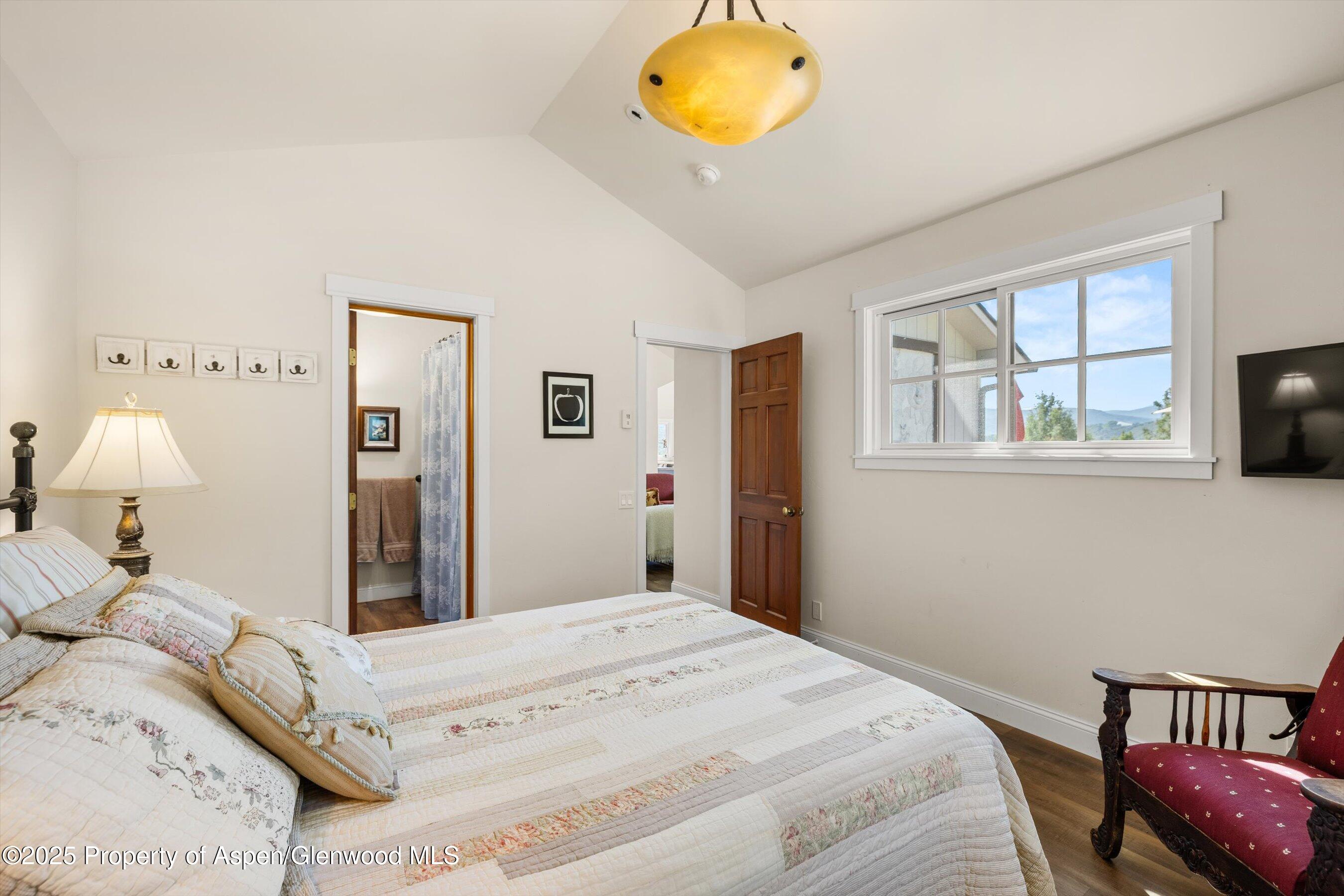148 Gateway Road Snowmass, CO 81654 - Photo 18 of 32 a bedroom with a bed and a window