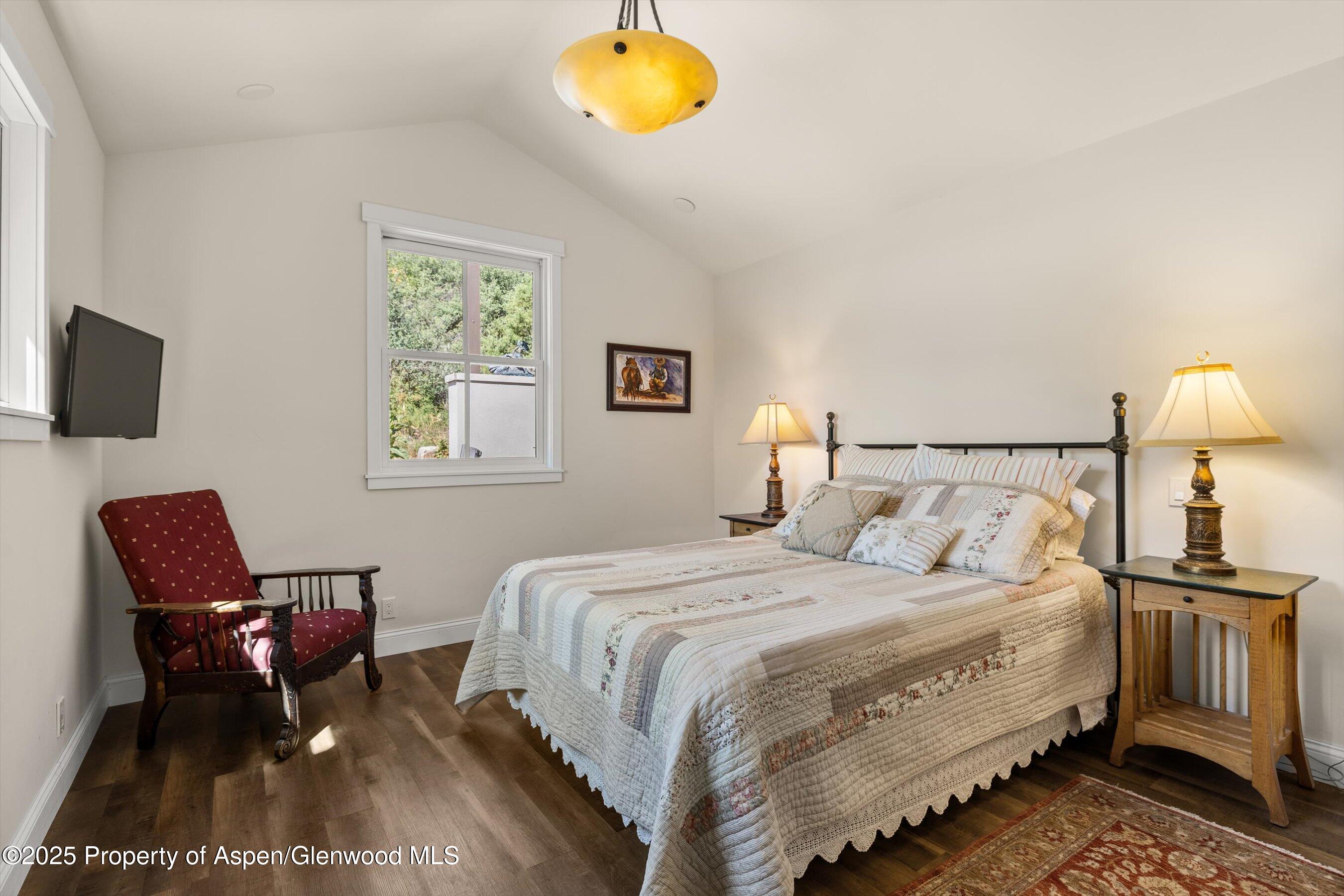 148 Gateway Road Snowmass, CO 81654 - Photo 19 of 32 a bedroom with a bed a couch and a potted plant