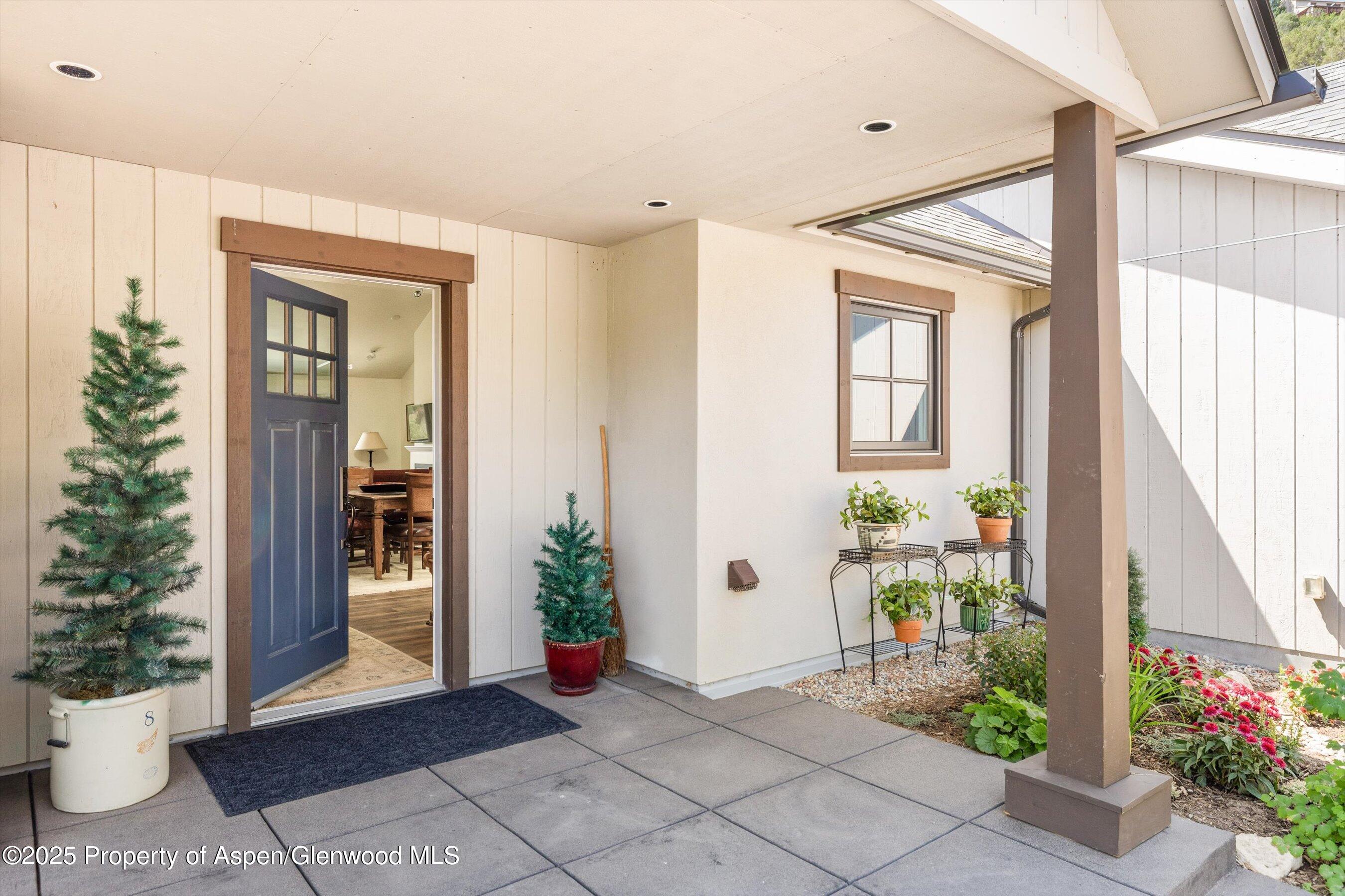 148 Gateway Road Snowmass, CO 81654 - Photo 24 of 32 a view of an entryway with flower in front of house