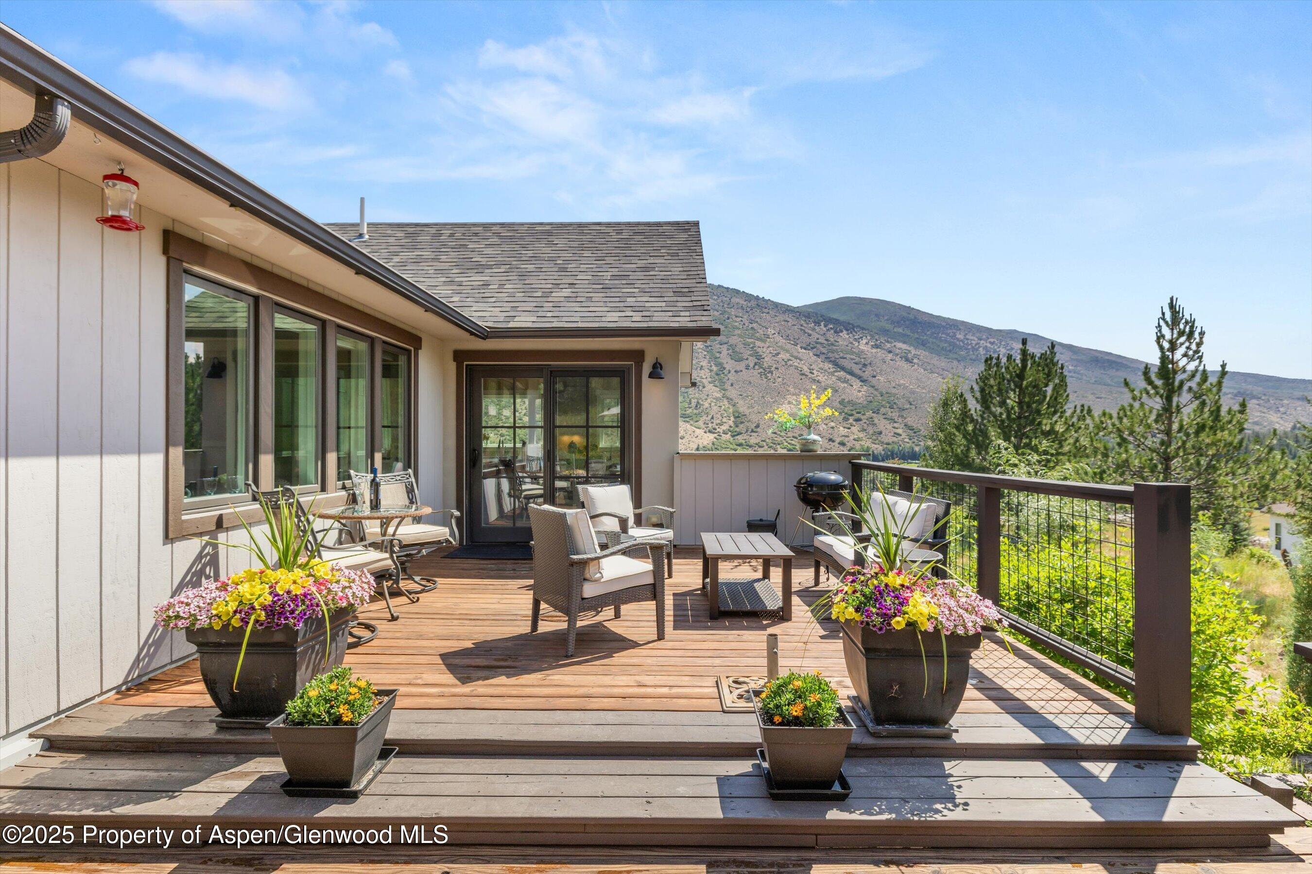 148 Gateway Road Snowmass, CO 81654 - Photo 31 of 32 a view of a patio with couches table and chairs and potted plants