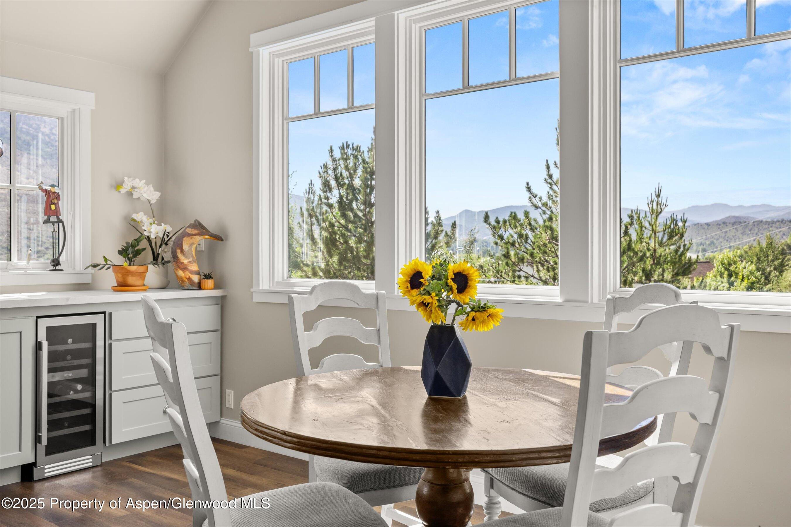 148 Gateway Road Snowmass, CO 81654 - Photo 6 of 32 a dining room with furniture a potted plant and wooden floor