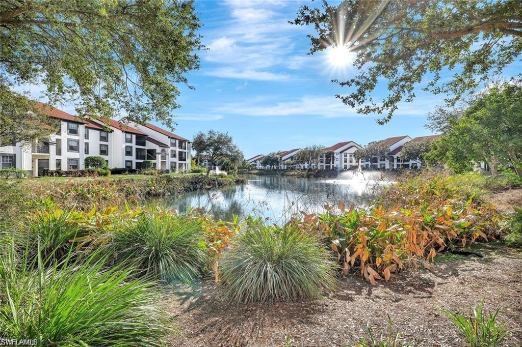 7975 Preserve Circle, Unit 1013 Naples, FL 34119 - Photo 4 of 16 a view of a lake with a house in the background