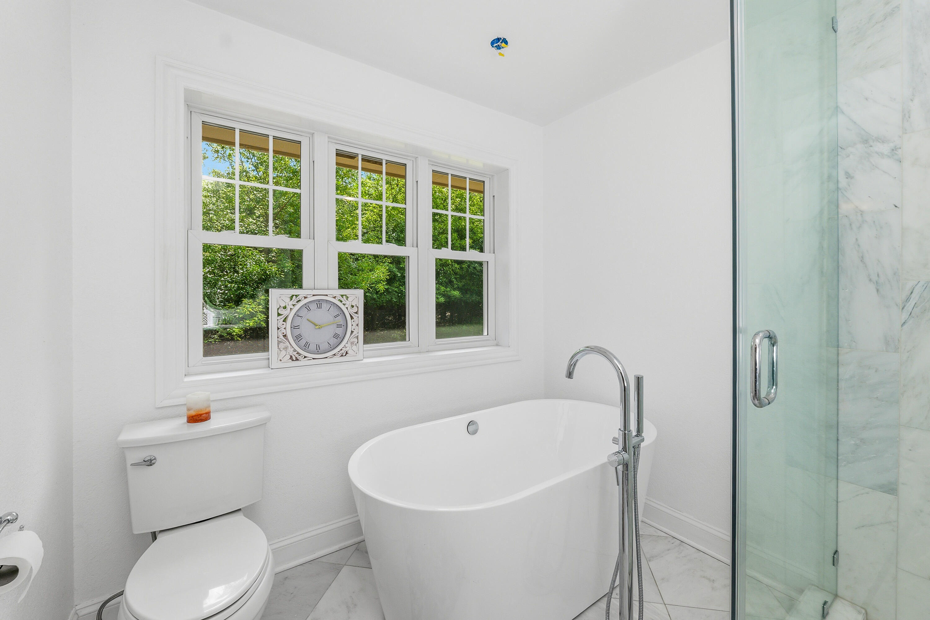 34899 Pabst Road Summit, WI 53066 - Photo 16 of 38 Updated primary bath with a soaking tub, calming finishes, and a relaxing retreat-like feel.