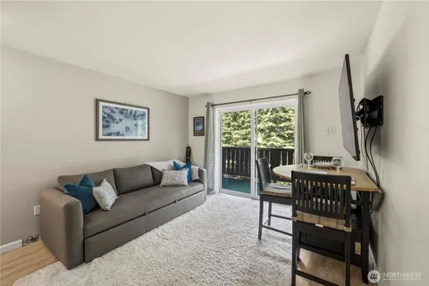 a living room with furniture and a dining table with kitchen view