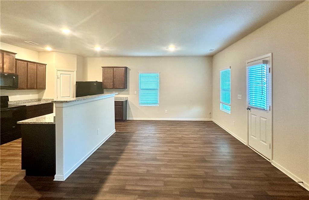 916 Independence Avenue Pendergrass, GA 30567 - Photo 11 of 30 a view of a kitchen with wooden floor and electronic appliances
