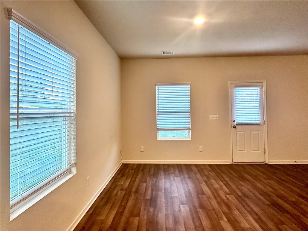 916 Independence Avenue Pendergrass, GA 30567 - Photo 12 of 30 a view of an empty room with wooden floor and a window