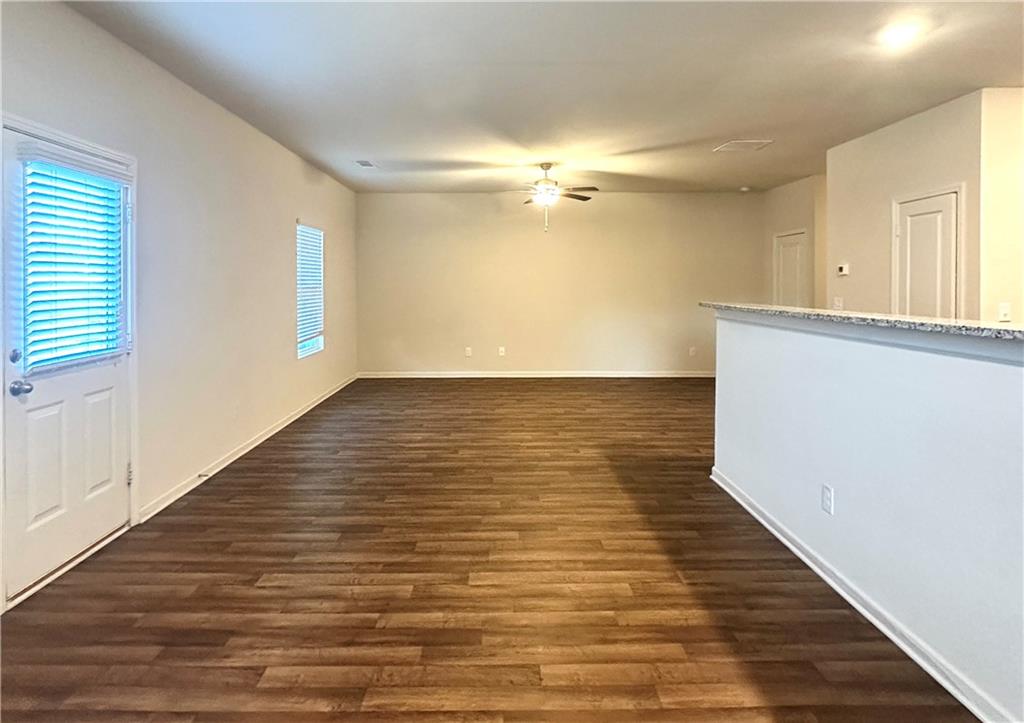 916 Independence Avenue Pendergrass, GA 30567 - Photo 13 of 30 a view of empty room with wooden floor and fan